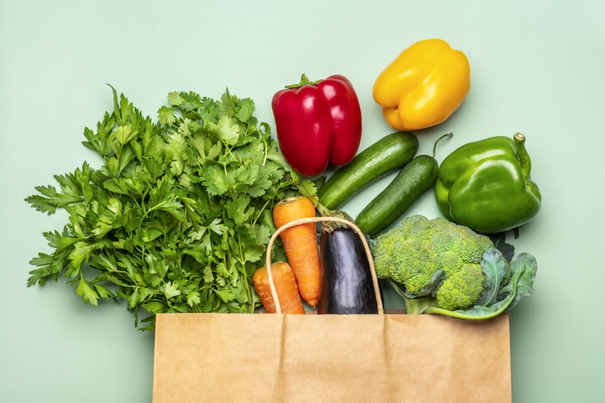 Paper grocery bag full of produce.