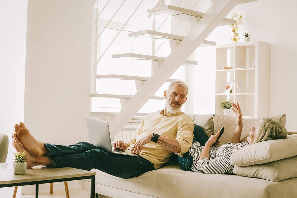 Fit older couple talk on the couch