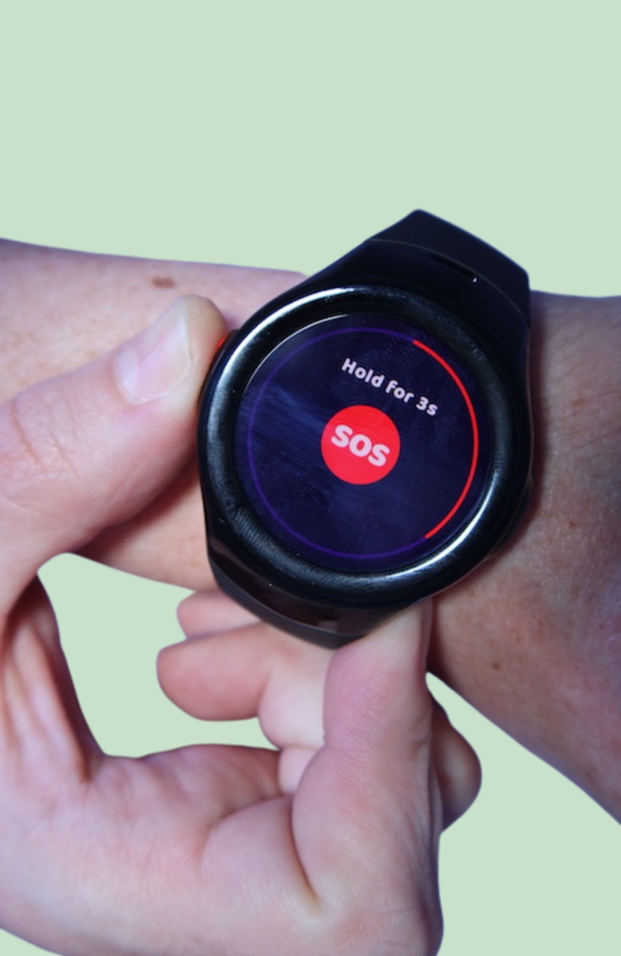 MGMove watch on wrist displays “Hold for 3s” message as the wearer’s thumb presses the side red button