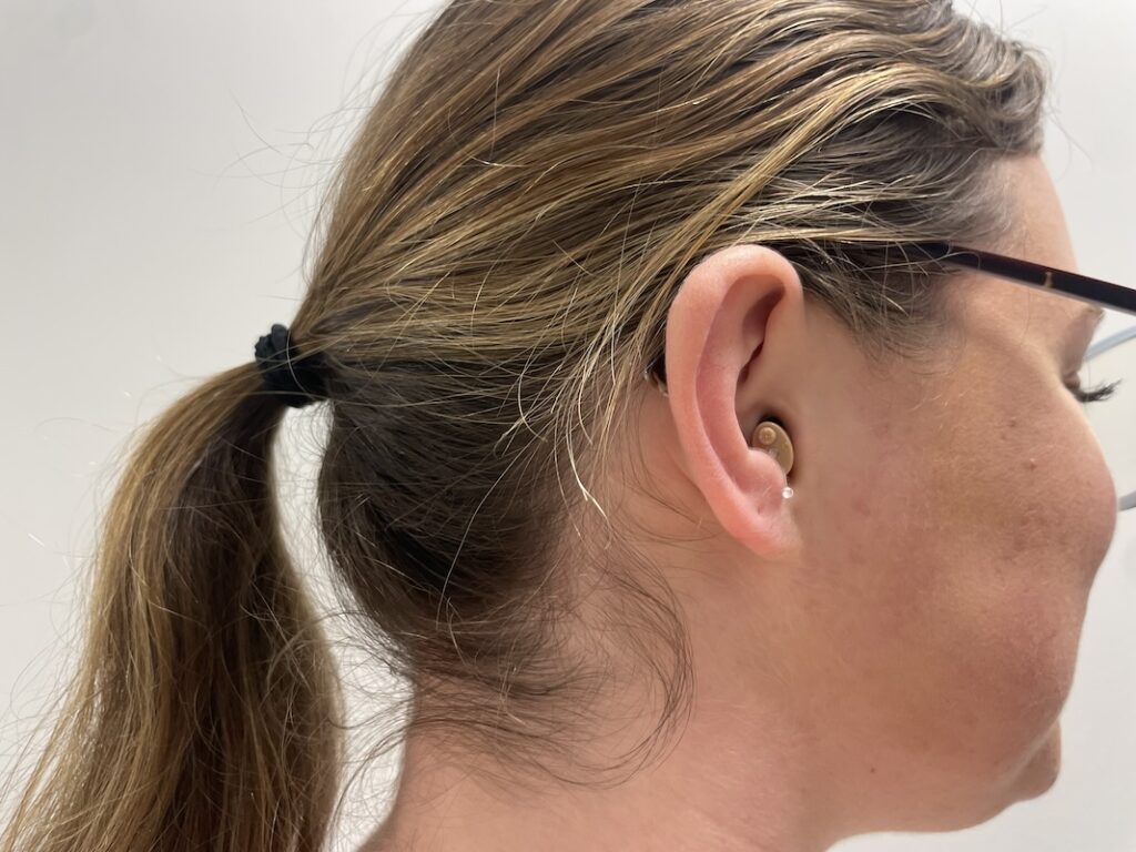 Woman with a New XS in her ear